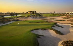 Lush green golf course landscape with sculpted sand bunkers and manicured turf in the UAE