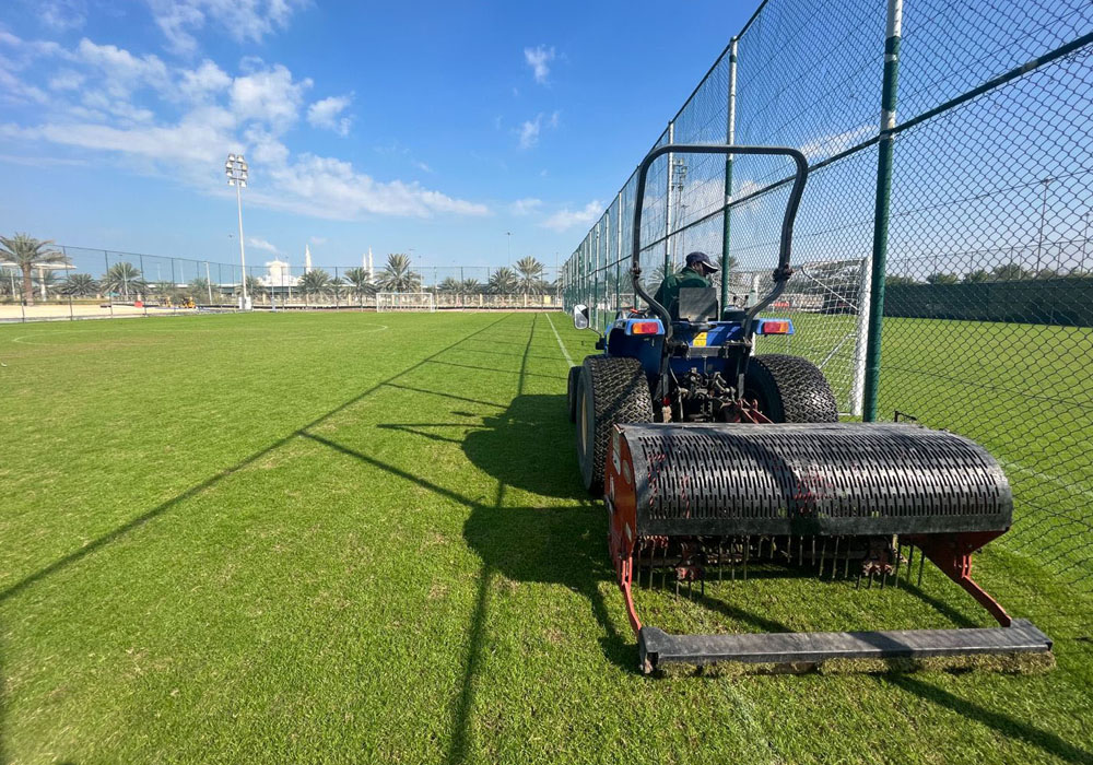 Sports turf maintenance in action — precision ground work that keeps playing surfaces in championship condition.
